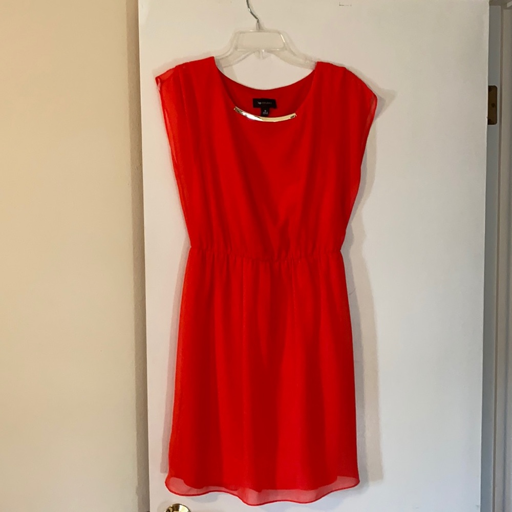 Coral dress with gold accent.